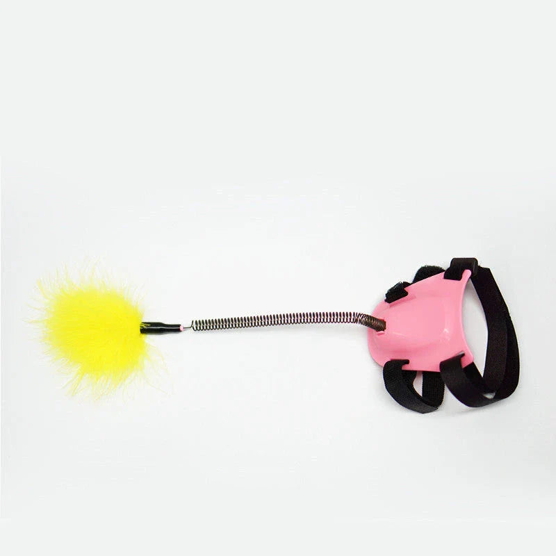 Playful cat chasing and pouncing on a feather-tipped wand toy designed to engage their natural hunting instincts