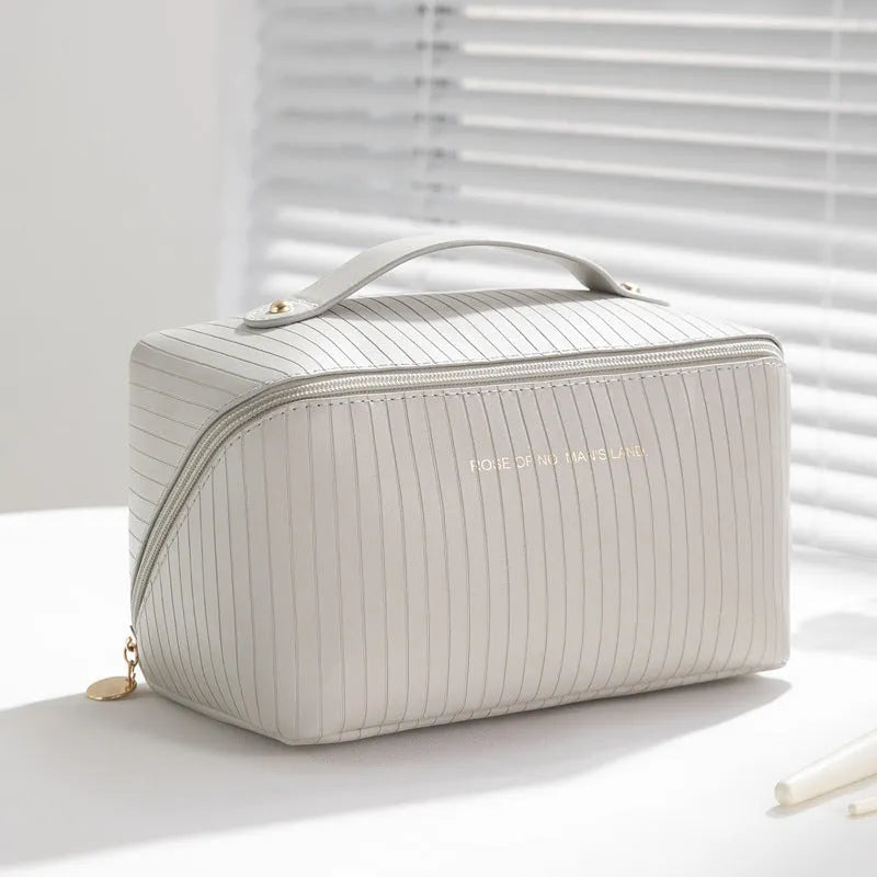 Beige cubic makeup bag with vertical pattern measuring 22.5 by 12.5 by 12.5 centimetres