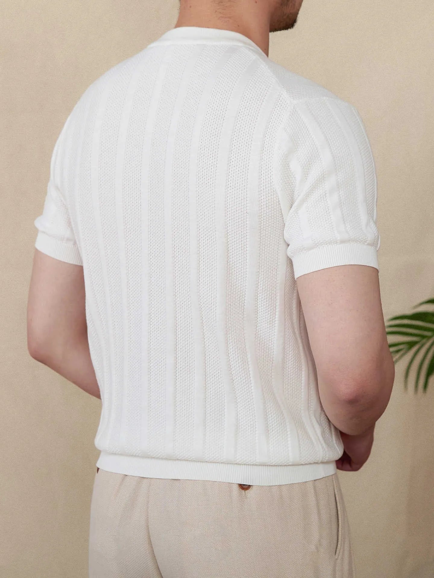 Men's creamy-white cotton T-shirt with a Henry collar and subtle sunken stripe pattern on the chest.