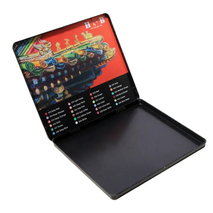 Metal tin box open to show 24 water-soluble coloured pencils with brush tips in assorted colours.