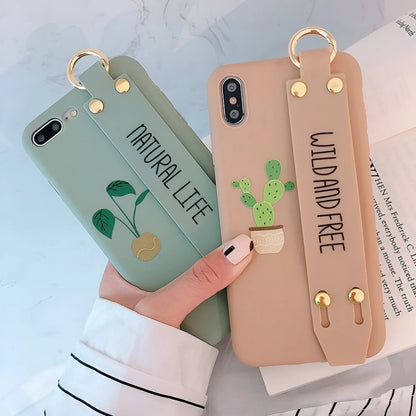 Green iPhone case with graffiti design and integrated wristband holder on back cover
