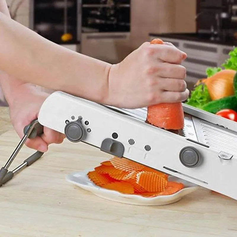 White kitchen vegetable slicer with stainless steel blades and adjustable thickness settings