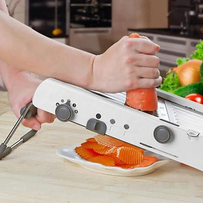 White kitchen vegetable slicer with stainless steel blades and adjustable thickness settings
