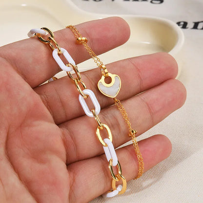 Women's stainless steel bracelet with double-layered heart design and resin accents, showing adjustable clasp and electroplated finish