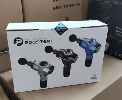 Black and white handheld percussion muscle massage gun with four interchangeable foam heads on a grey background.