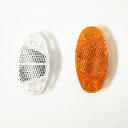 White and yellow plastic bicycle reflector for spoke mounting measuring 7.2 by 3.5 centimetres