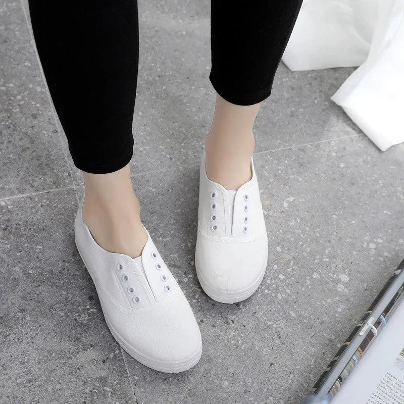 A pair of low-top canvas casual trainers in a choice of colours, shown on a flat surface.