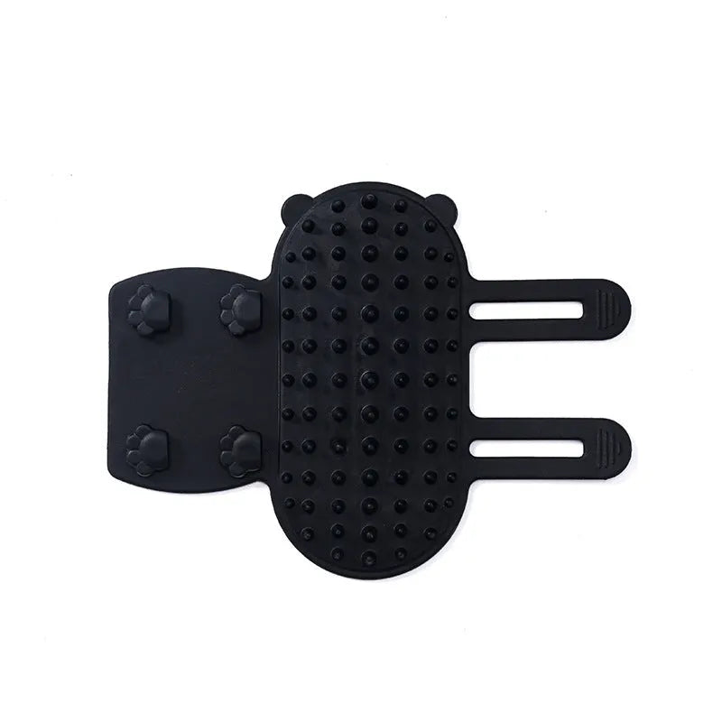 Silicone cat grooming comb with adjustable strap mounted on a table leg, shown in green.