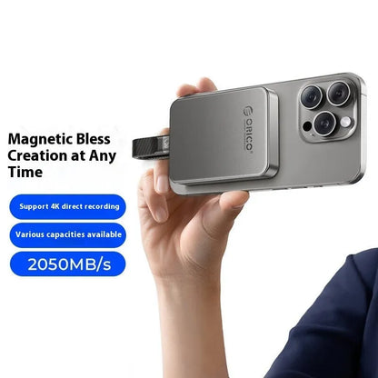 Grey ultra-thin Magnetic Mobile Solid State Drive with magnetic ring and USB C cable on a white background.