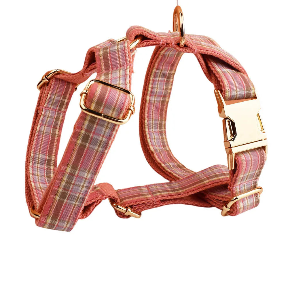 Red plaid cloth dog collar and leash set with matching bow on a white background