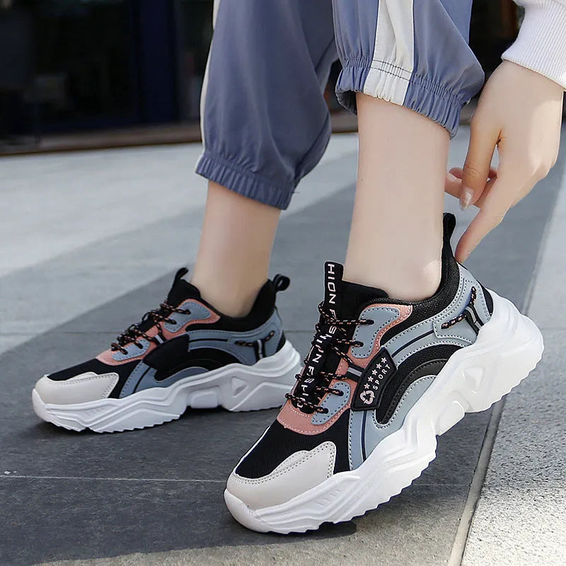 White women's thick-soled casual sports shoes with mesh upper, round toe, and buckle detail.