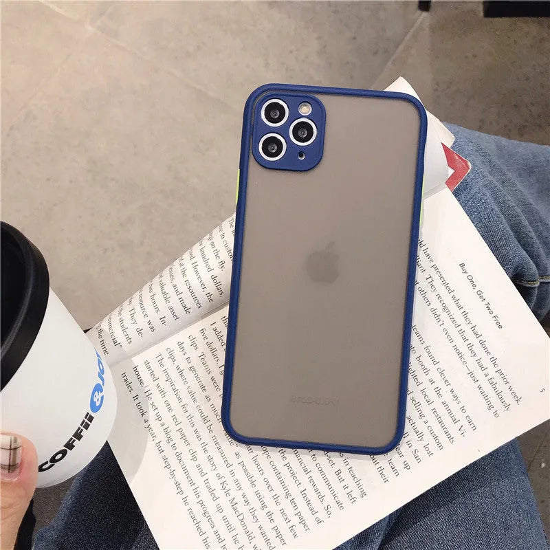 Solid colour silicone shockproof protective case for iPhone models on a table.