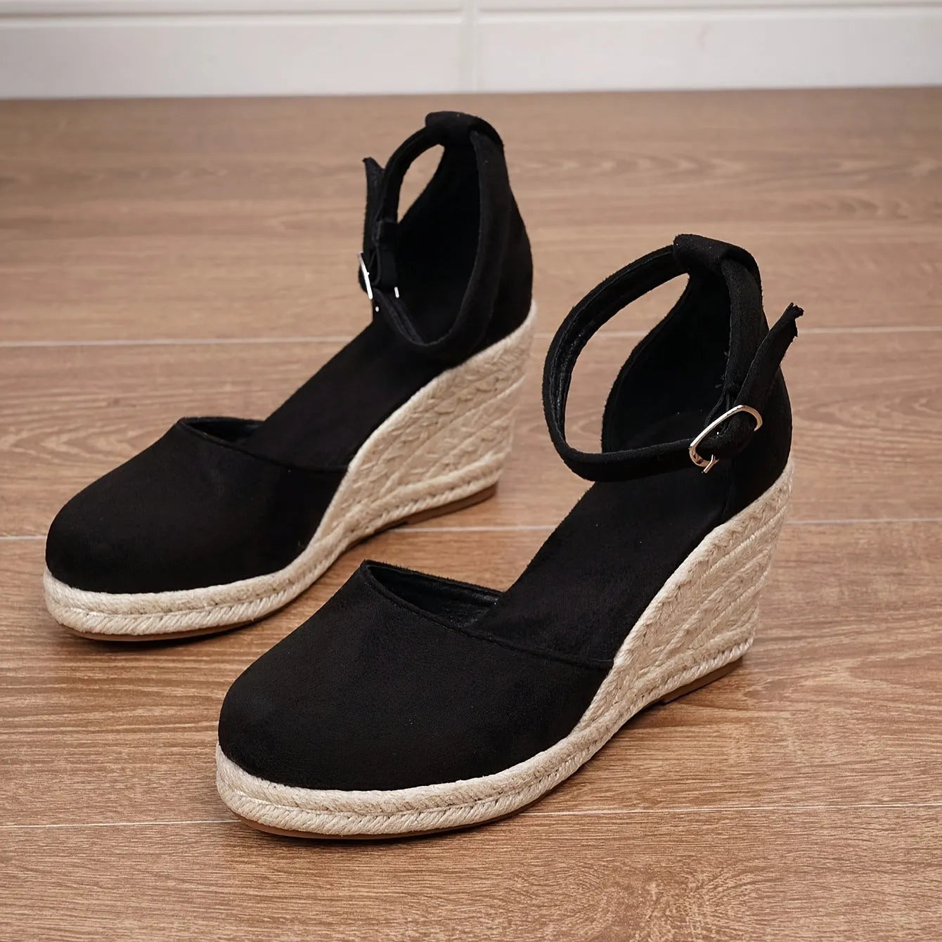 Women's Roman-style wedge sandals in suede with buckle fastening, shown in apricot and black colours