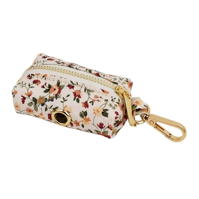 Small white flower decoration on a cloth dog collar and leash set with matching vest and bow.