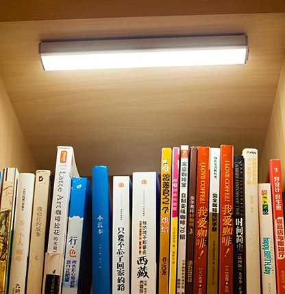 Wireless LED wardrobe light in 300mm size with motion sensor and charging pad, warm white glow, mounted on shelf