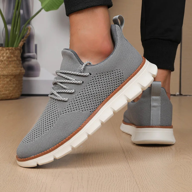 Men's low-heel casual sneaker in woven mesh fabric with round toe and shallow cut, available in grey and black colour variants with sizes from 39 to 48 for youth and adult male wearers