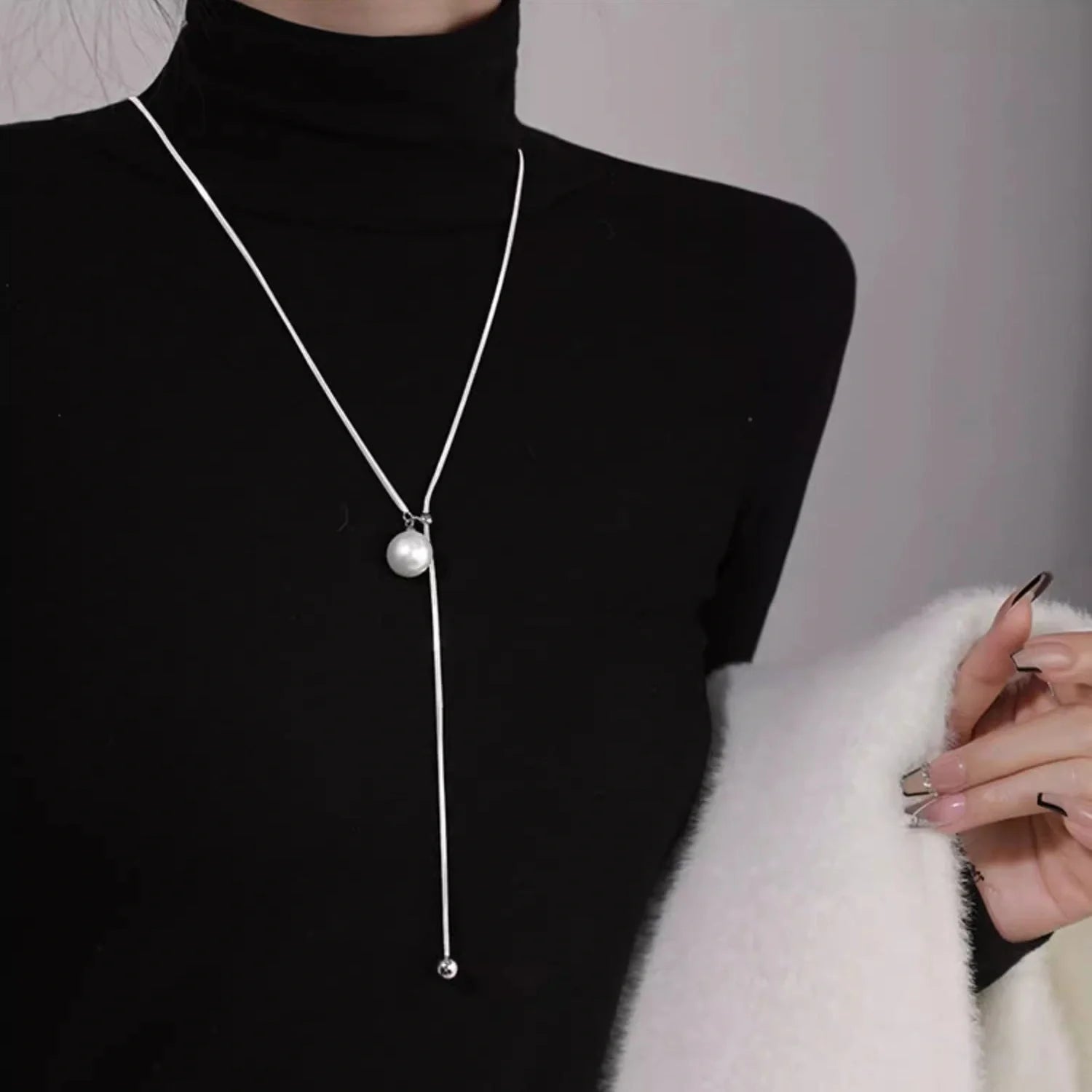 Elegant platinum-plated round ball chain necklace with sleek snake-bone design, a timeless fashion accessory for modern women.