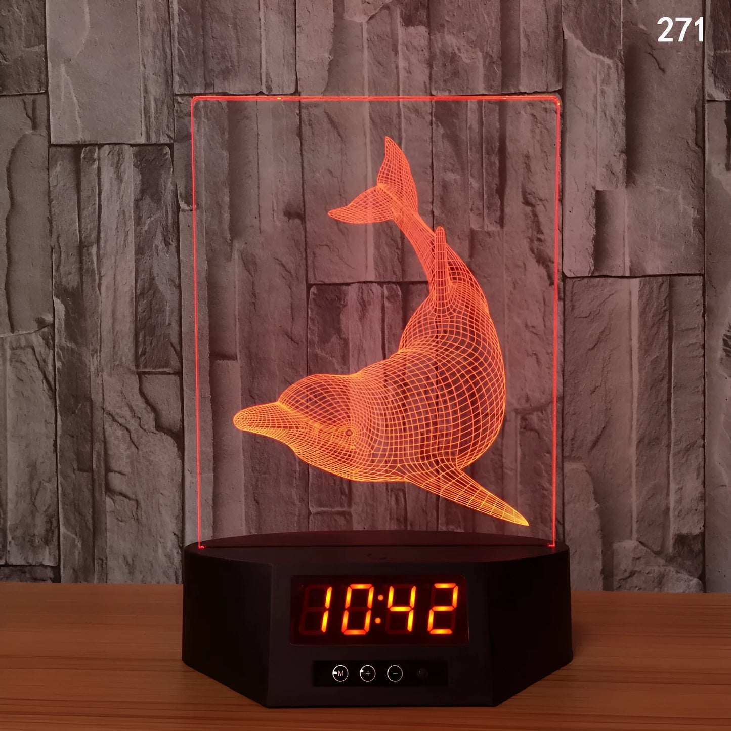 Glowing 3D dolphin LED night light with wireless charging base and remote control on bedside table