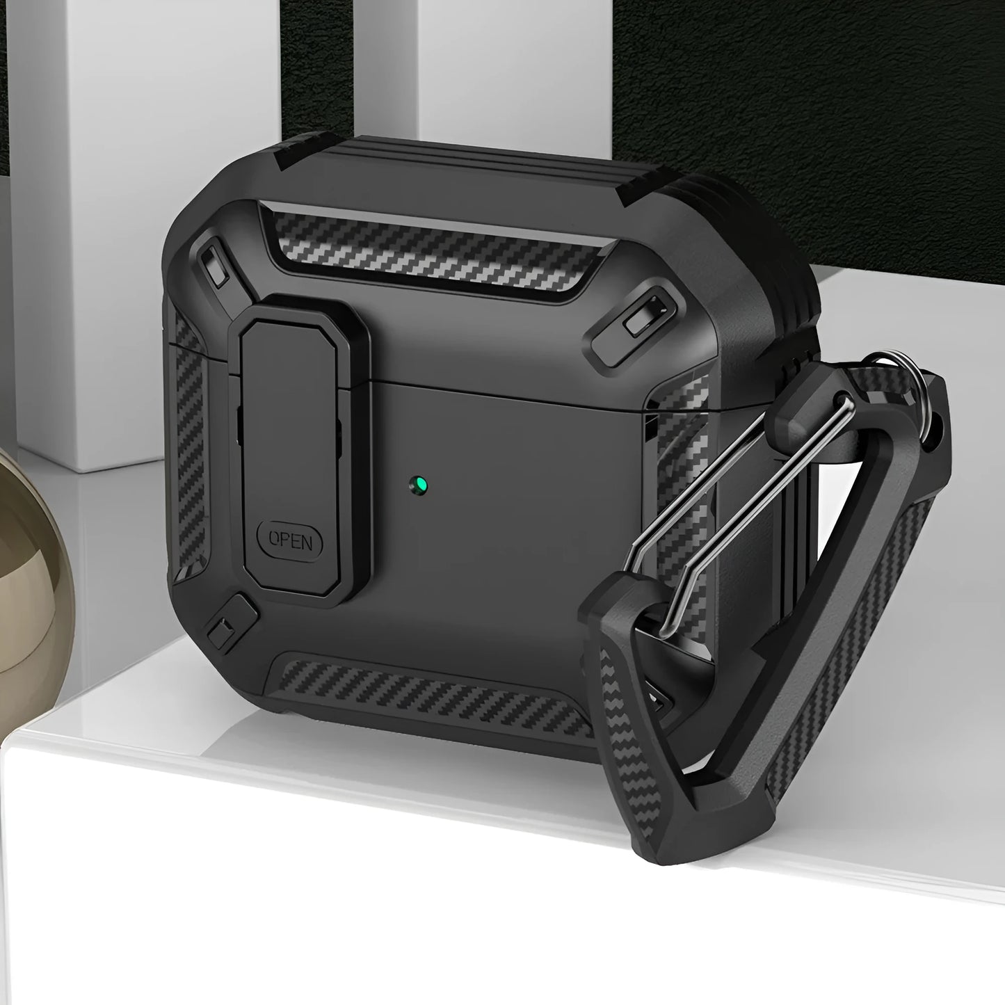 Hard plastic clamshell case for AirPods with a carabiner hook attached, shown in a black and yellow two-tone colour.
