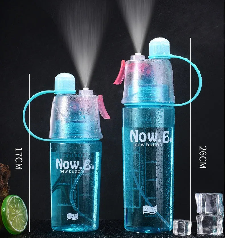Green mist spray water bottle with clear volume scale and leakproof lid on a wooden table.