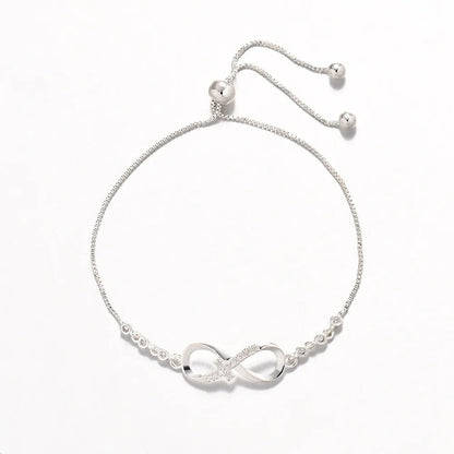 Diamond studded pull-out bracelet with infinite 8-shaped design, copper plastic, 26cm circumference, 20.0mm x 8.0mm
