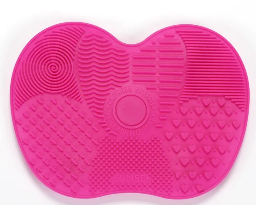 Silicone makeup brush cleaning pad, 15.5 x 12 cm, shown as a coloured brush cleaner mat for cleansing makeup brushes.