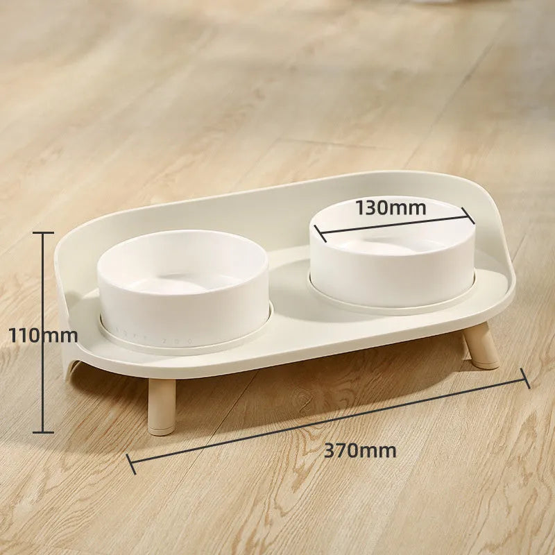 Green tilted pet feeder with adjustable stainless steel frame and two food bowls for cats and dogs