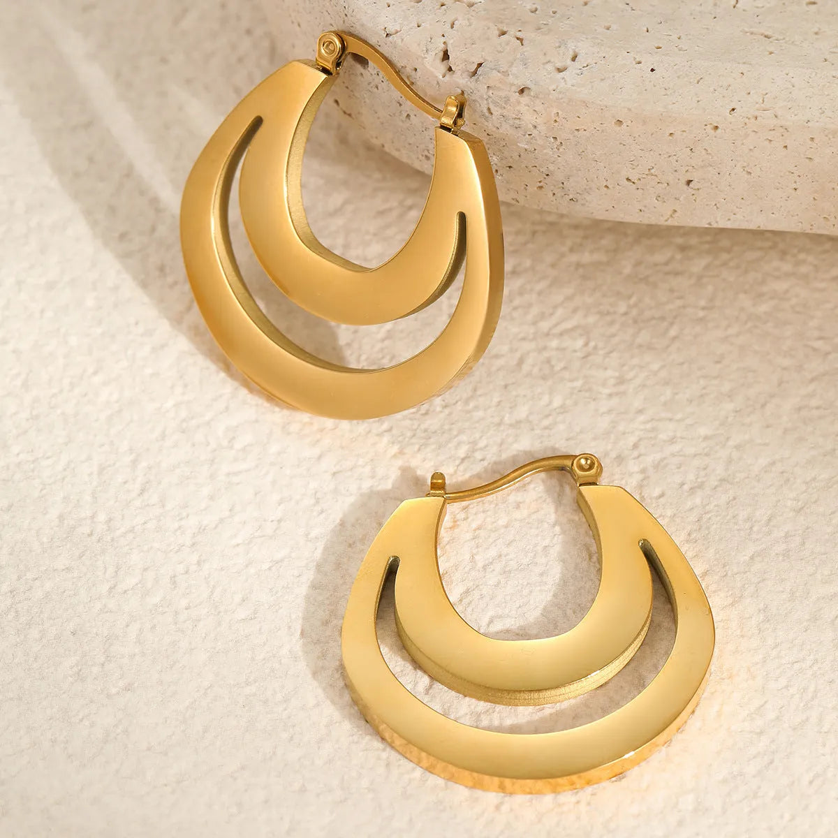 Geometric French earrings with gold plating and round ring design elements
