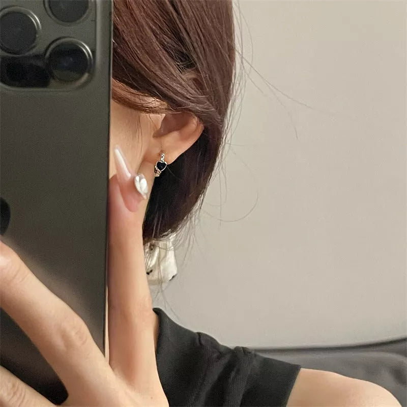Black love heart earrings for women with alloy construction and ear clip design