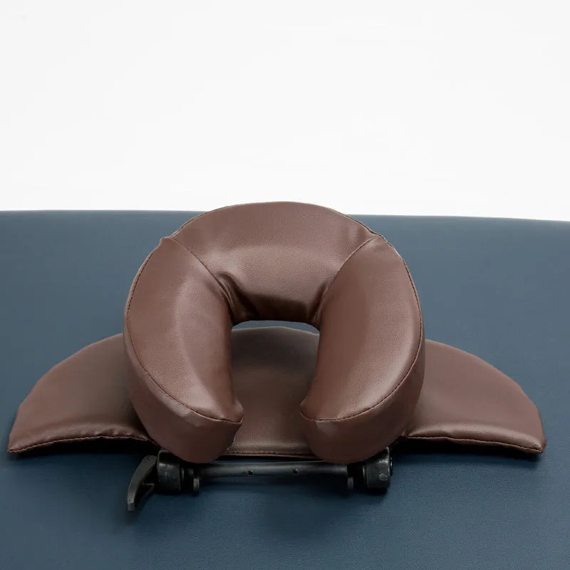 U-shaped black SPA facial massage pillow with adjustable height, shown with its zippered nylon carry case