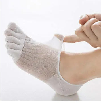 Pair of solid colour modal five-finger invisible socks on a wooden surface, showing toe separation and low-cut design.