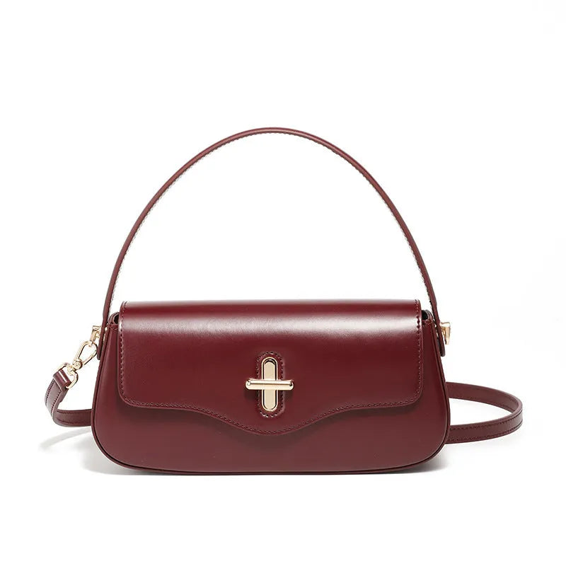 Genuine leather baguette handbag in horizontal square shape with clamshell opening and internal zip compartments