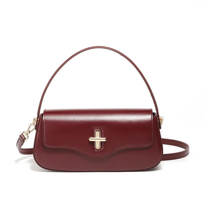 Genuine leather baguette handbag in horizontal square shape with clamshell opening and internal zip compartments