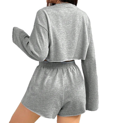 Grey women's long-sleeved T-shirt and shorts polyester lounge set laid flat.