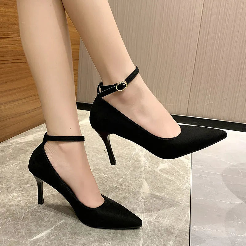 Women's black stiletto heel pumps with skull pattern and buckle detail, showing 8cm heel height