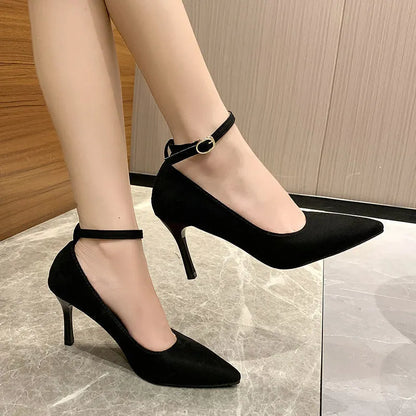Women's black stiletto heel pumps with skull pattern and buckle detail, showing 8cm heel height