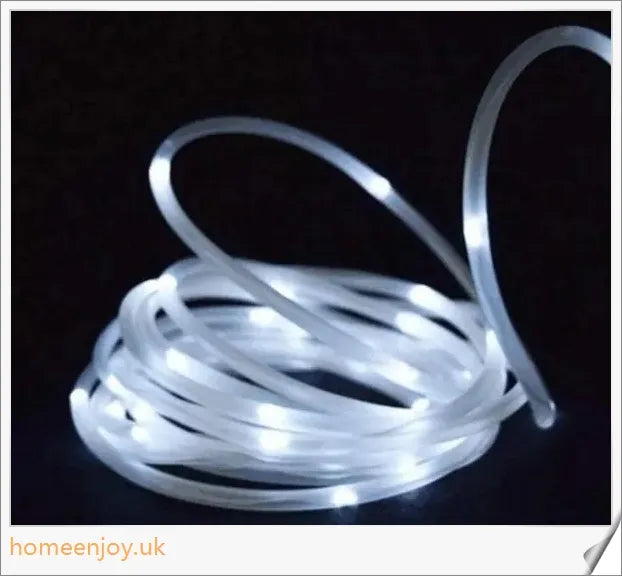 40ft solar-powered garden pathway light strips in use, illuminating a winding garden path with a warm, enchanting glow
