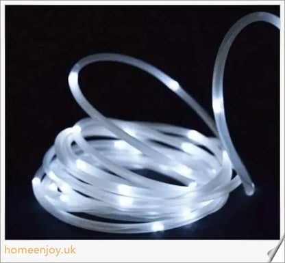 40ft solar-powered garden pathway light strips in use, illuminating a winding garden path with a warm, enchanting glow