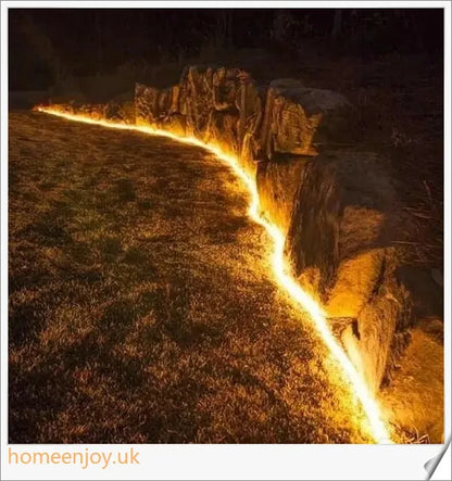 40ft solar-powered garden pathway light strips in use, illuminating a winding garden path with a warm, enchanting glow