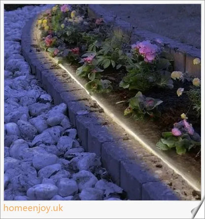 40ft solar-powered garden pathway light strips in use, illuminating a winding garden path with a warm, enchanting glow