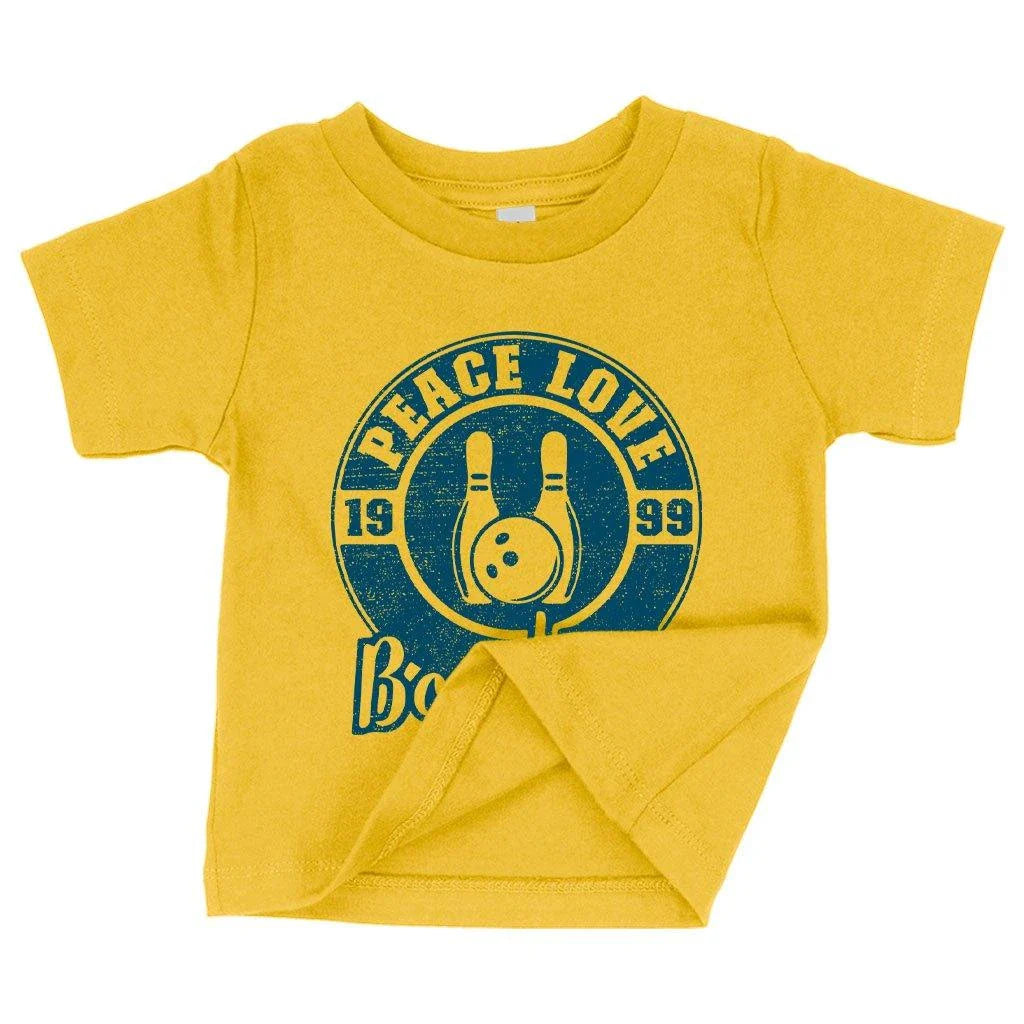 A soft, white baby t-shirt with a cute bowling-themed design, perfect for infants and toddlers.