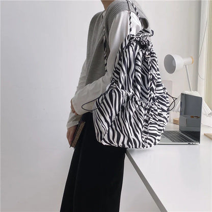 Creative drawstring bucket bag in white, black, brown, and zebra print patterns - a stylish and versatile women's tote bag made of high-quality polyester material