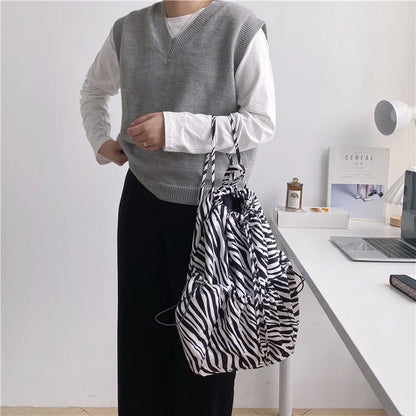 Creative drawstring bucket bag in white, black, brown, and zebra print patterns - a stylish and versatile women's tote bag made of high-quality polyester material