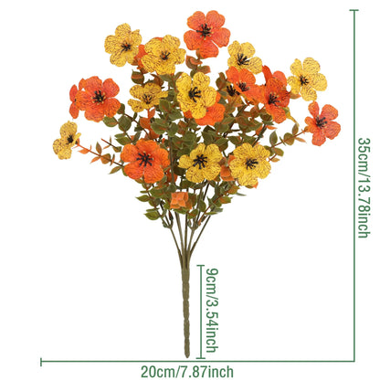 Artificial flower bouquet in autumn colours of red, yellow, and orange made from plastic and silk.