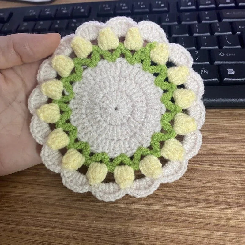 Handmade woven floral coaster in cotton and linen, showing pink, purple, red, and yellow colour options