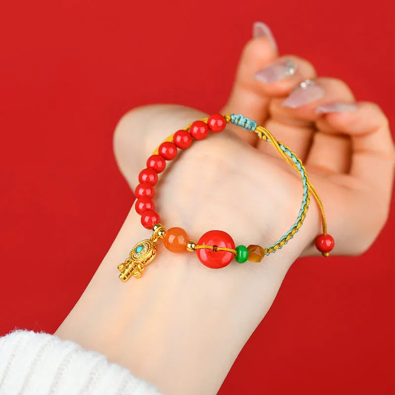 Hand-woven cinnabar peace blessing bracelet in emperor red sand colour with geometric design