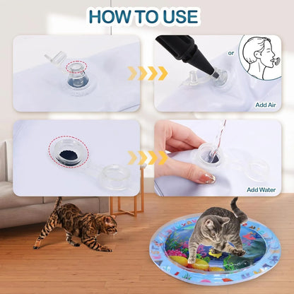 Blue ocean-themed cat water play mat with floating fish toys inside an inflated square border on a wooden floor.