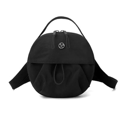 Out shoulder crossbody messenger bag in nylon showing interior zipped changing bag, phone pocket, and document compartment.