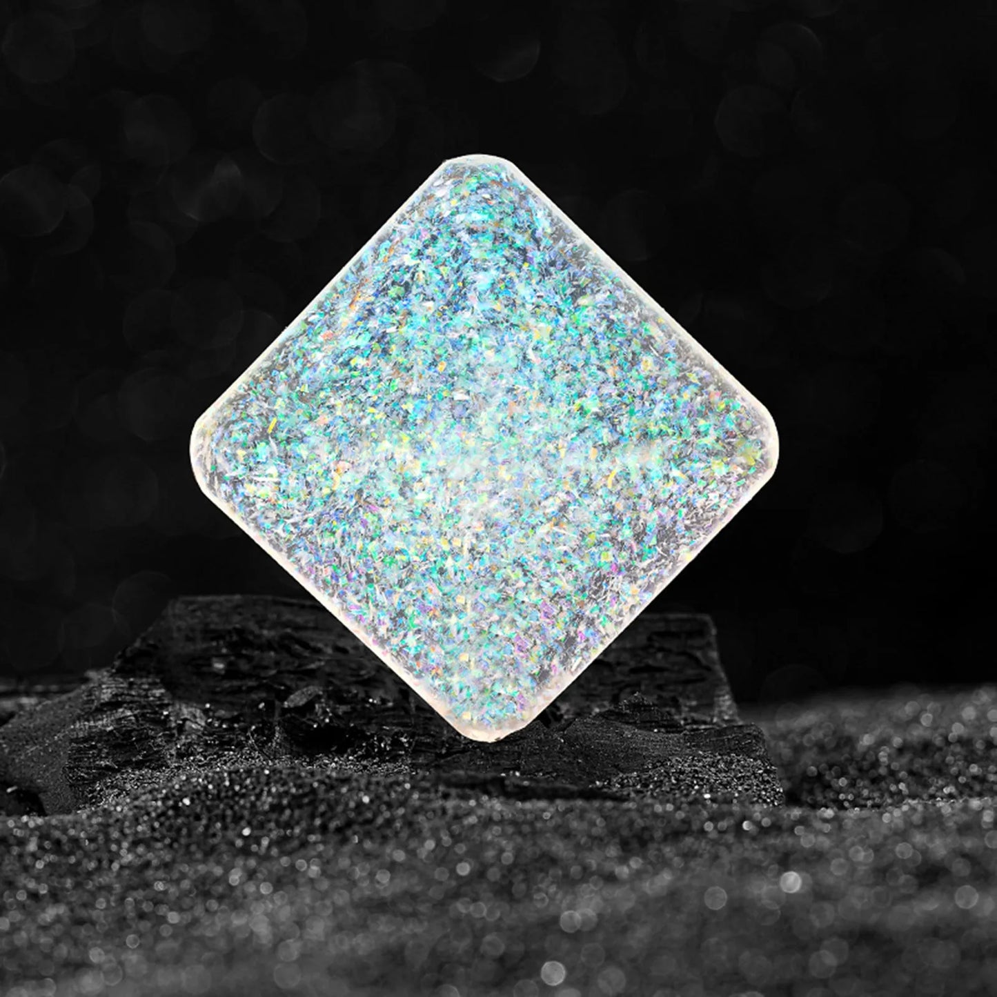 Galactic edition pocket gyro desk toy on a surface, showing its quadrilateral resin construction and celestial colour design.