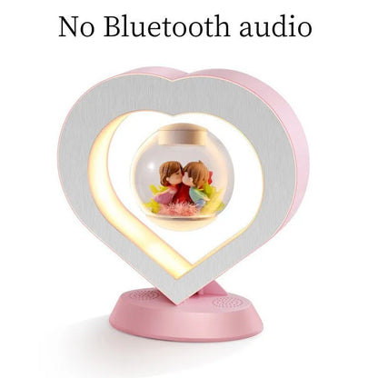 Pink rose eternal flower floating in magnetic levitation LED night light with triangular base and touch control